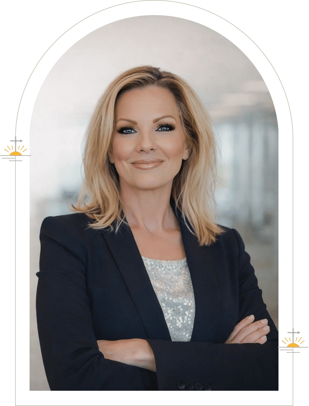 Professional woman with crossed arms smiling confidently.